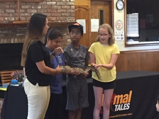 Photo of children holding an animal at library program